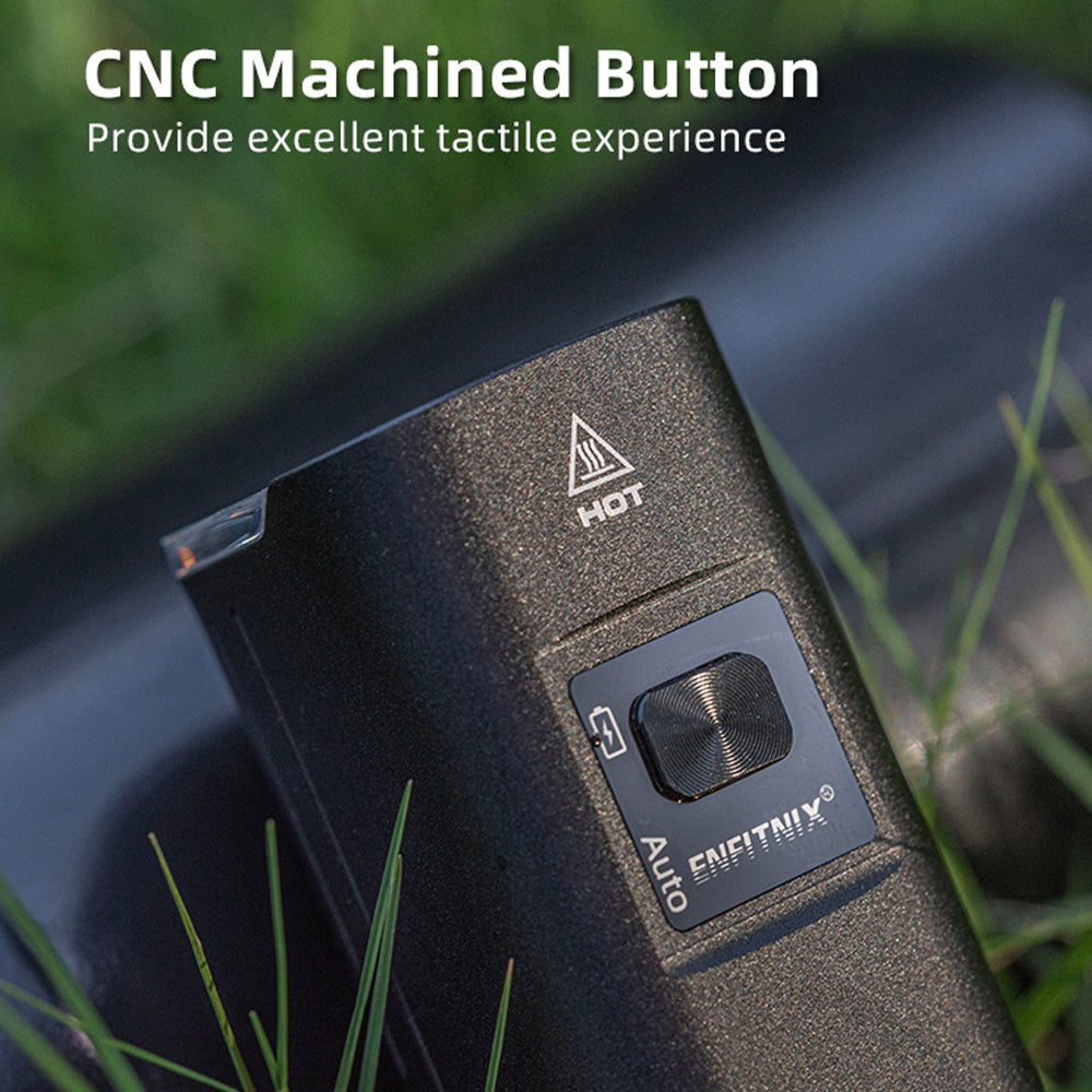 CNC machined button on a device with grass in the background