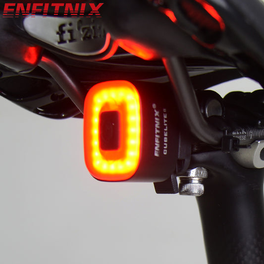 Bicycle tail light with ENFITNIX branding on a bike handlebar.