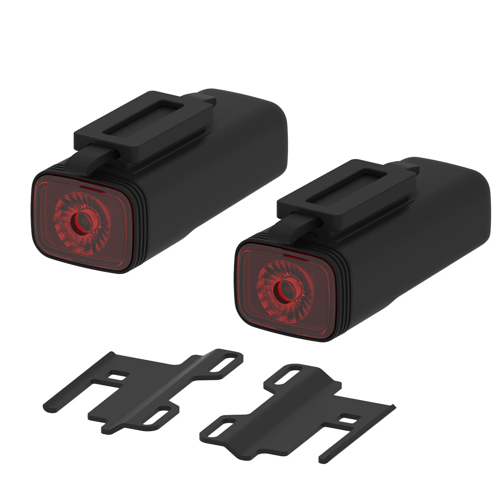 Two black bike lights with red lenses and mounting brackets on a white background