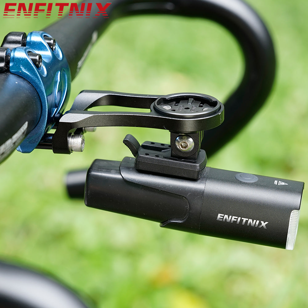 Bicycle handlebar with ENFITNIX bike computer and light on a blurred green background