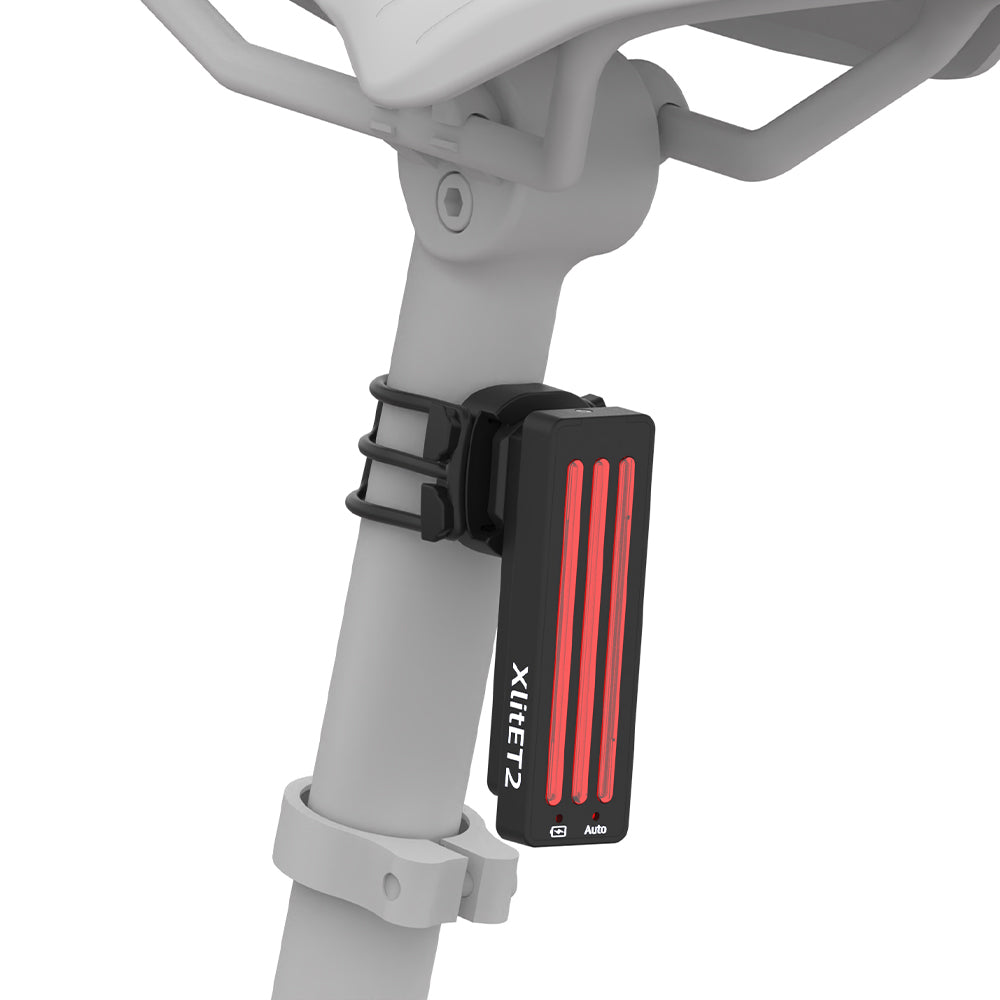 Bicycle light attached to a bike frame with 'XlitET2' branding on a white background