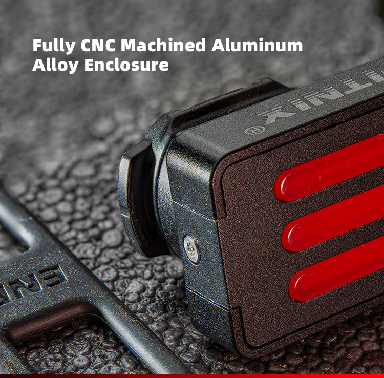 CNC machined aluminum alloy enclosure with red accents on a textured surface