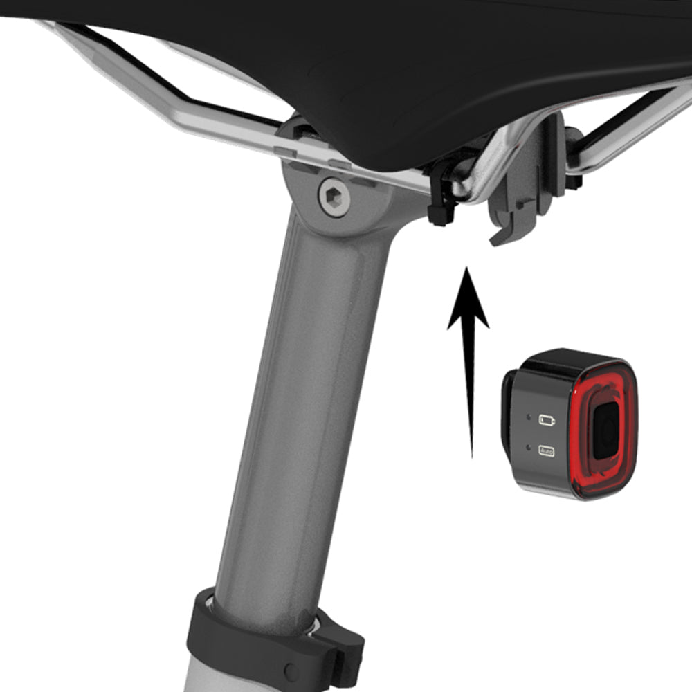 Bicycle tail light attached to a bike frame with an arrow pointing to it.