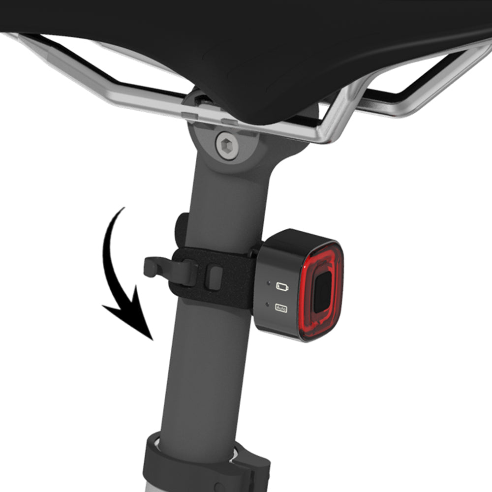 Bicycle seat post with a red light attachment on a white background