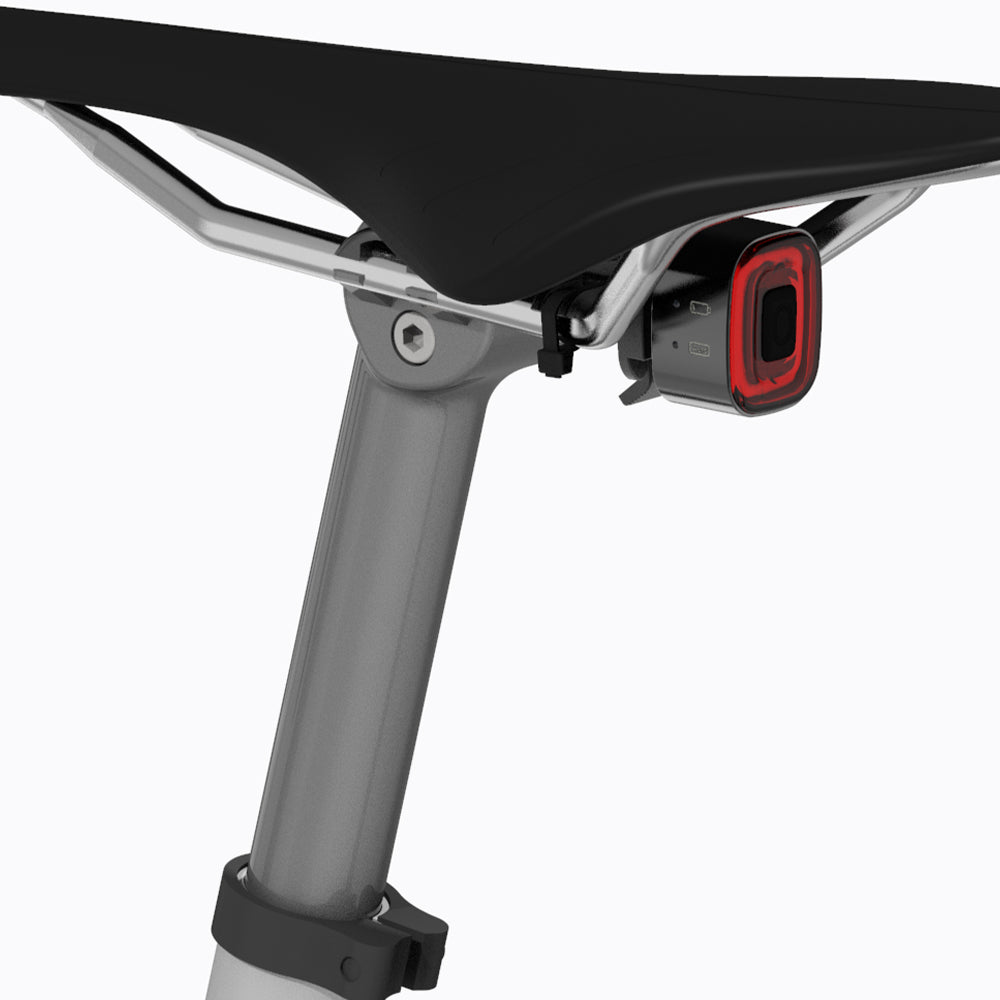 Close-up of a black and red bike lock attached to a bicycle frame on a white background