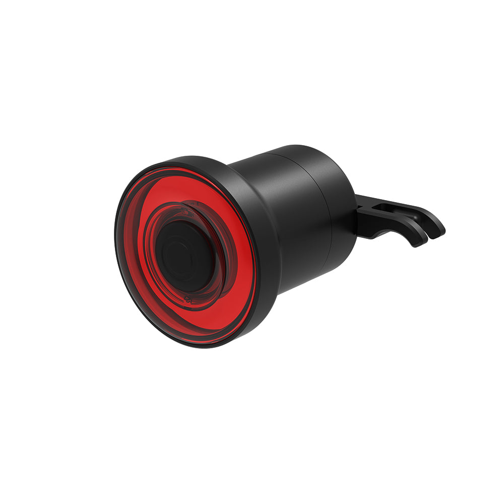 Black and red bicycle tail light on a white background