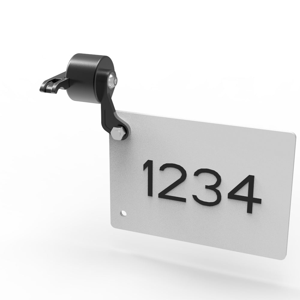 Metallic nameplate with numbers '1234' on a white background
