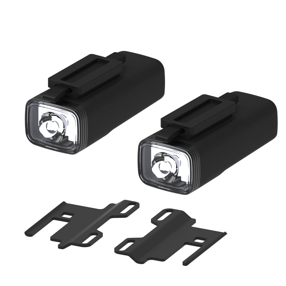 Two black Skateboard bike lights with mounting brackets on a white background