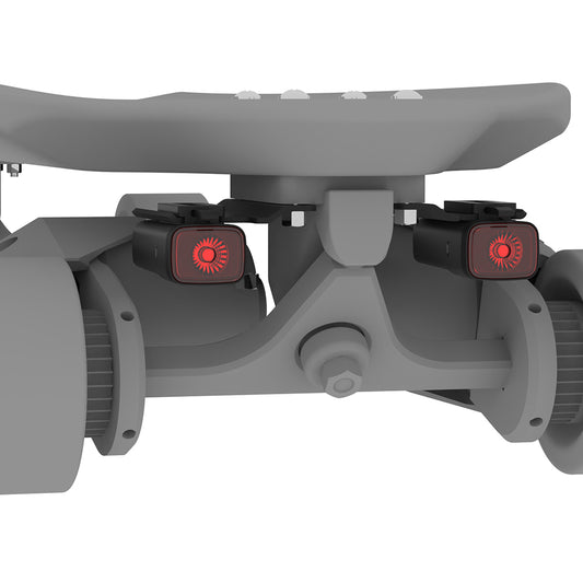 Close-up of a gray scooter with red lights on a white background