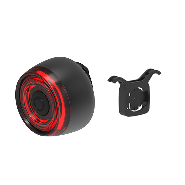 Black bike light with red interior and mounting bracket on a white background