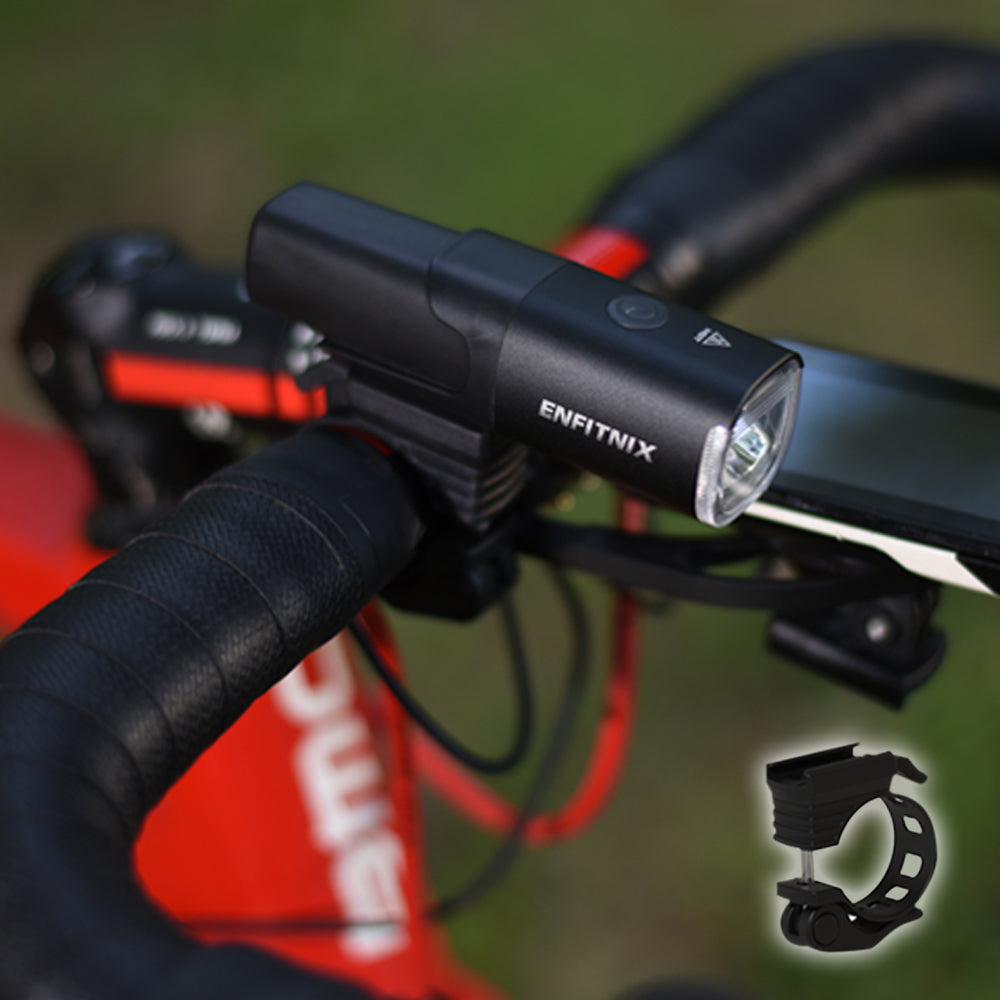 Bicycle light attached to handlebars with Enfitnix branding, on a blurred green background.