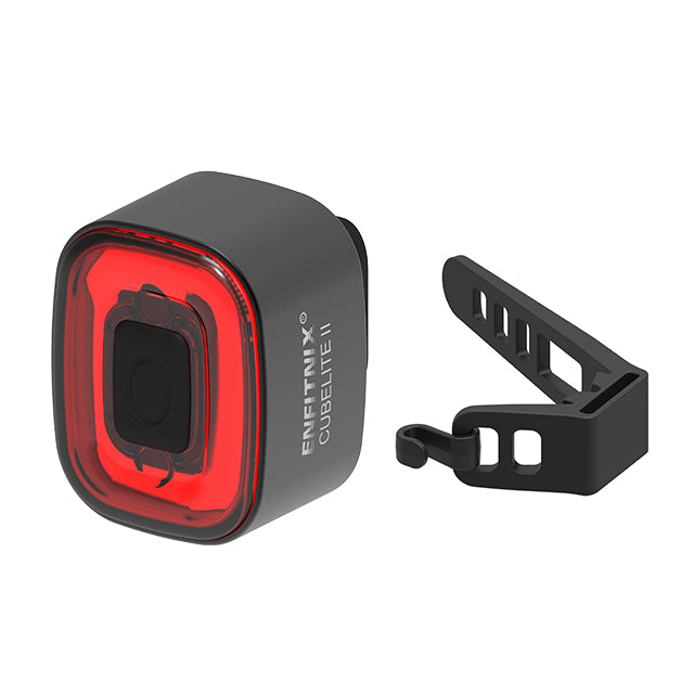 Black and red bike light with mounting bracket on a white background