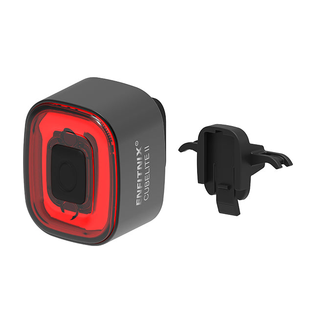 Black and red bike light with a clip on a white background