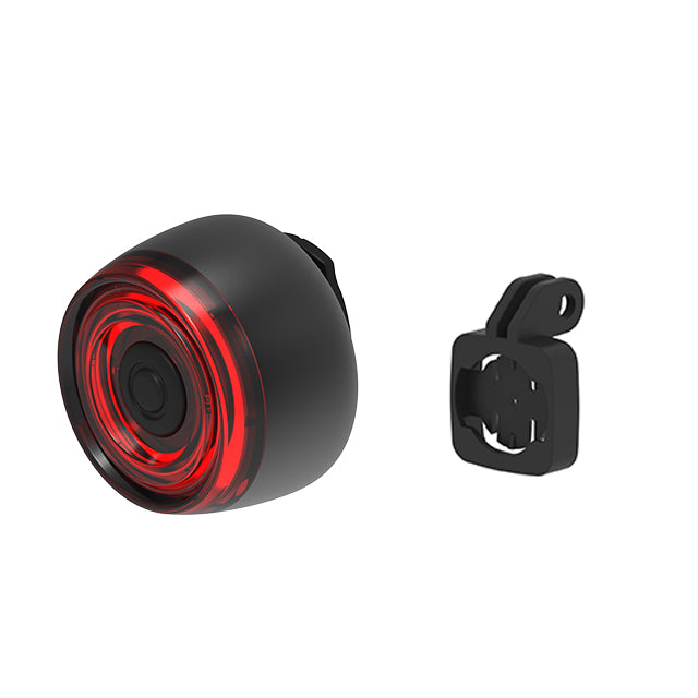 Black bike light with red interior and mounting bracket on a white background