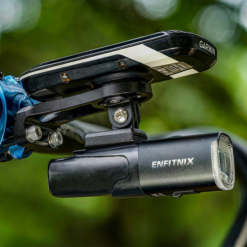 Bicycle light and mount with Enfitnix branding on a blurred green background