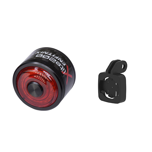 Red bicycle tail light with black mounting bracket on a white background