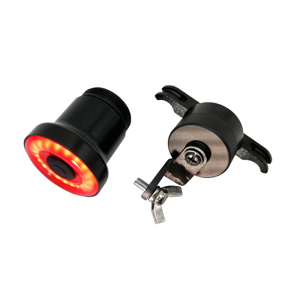 Black bicycle light with red LED on a white background