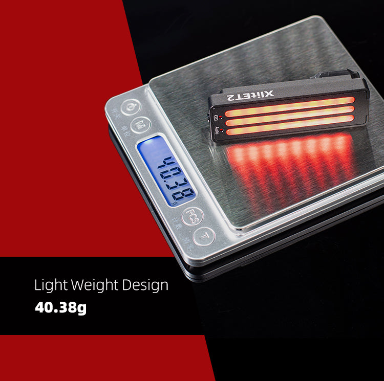 Digital scale with a small rectangular object on it, displaying weight on a red and black background.