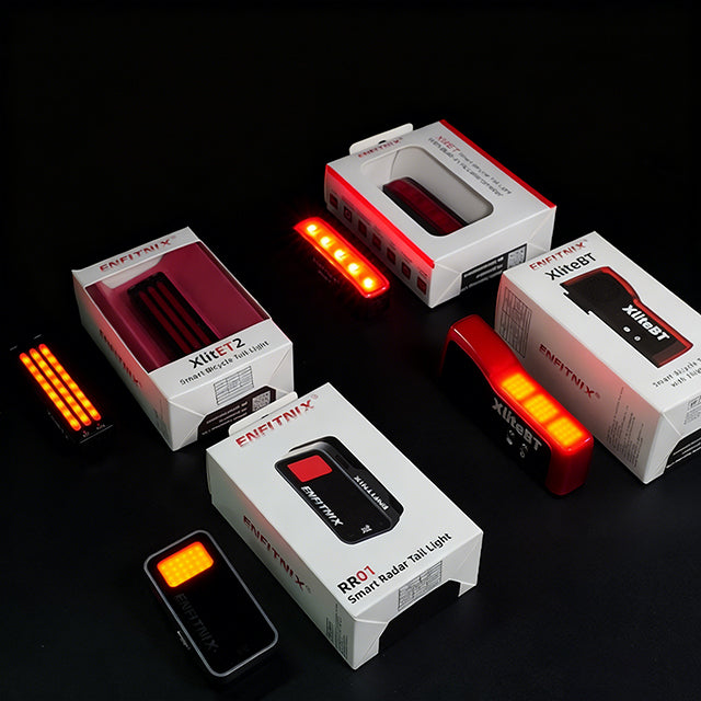 Multiple smart bike tail lights withpackaging on a dark surface