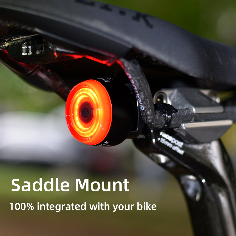 Bicycle saddle mount with red light and text 'Saddle Mount 100% integrated with your bike' on a blurred background