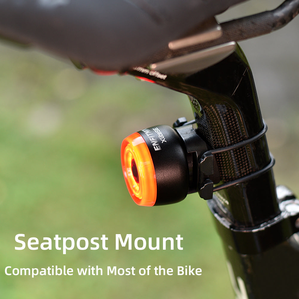 Bicycle light attached to a seatpost with a blurred green background