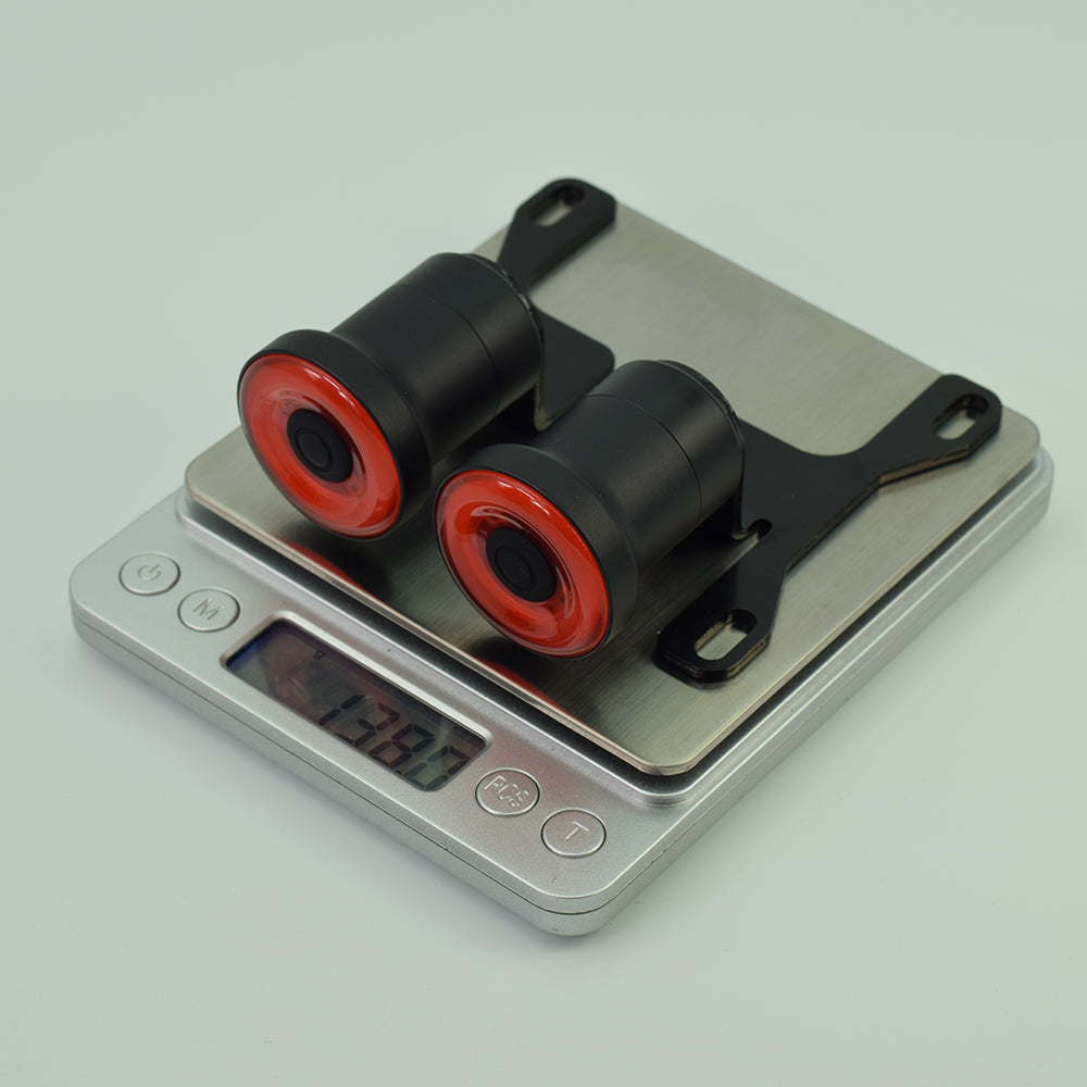 Black and red cylindrical objects on a digital scale with a light gray background