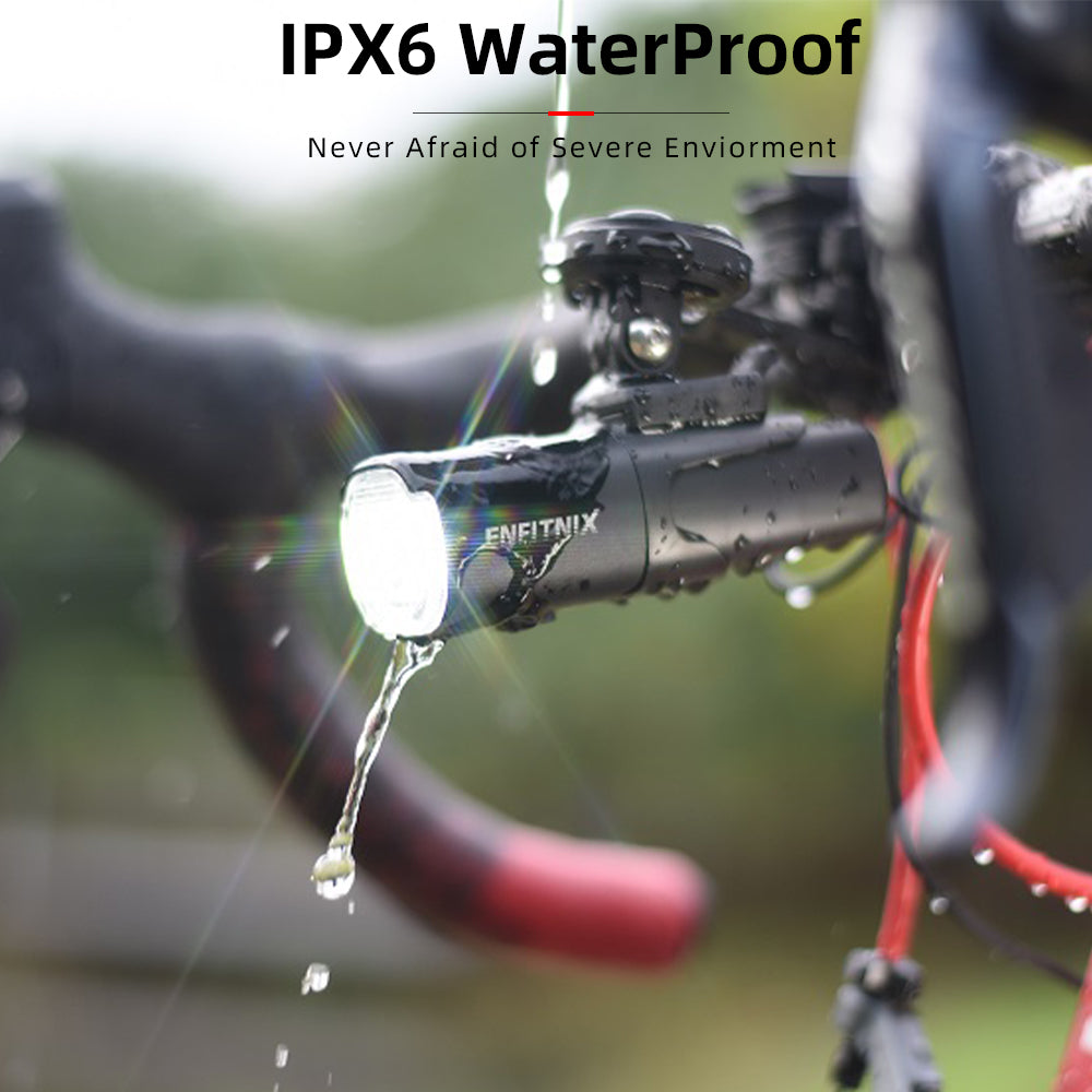 Bicycle light with IPX6 waterproof rating being tested in water droplets.