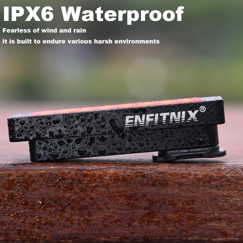 Black and red device with ENFITNIX branding on a wooden surface, featuring IPX6 waterproof text.